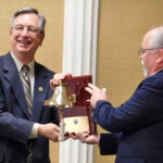 Jeff Hoedt receives an award from those who served under him at NBSAC97.