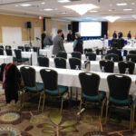 NBSAC97 room layout. See the horseshoe arrangement of tables at front (toward the projection screen) for the Council. Public sits in the back.
